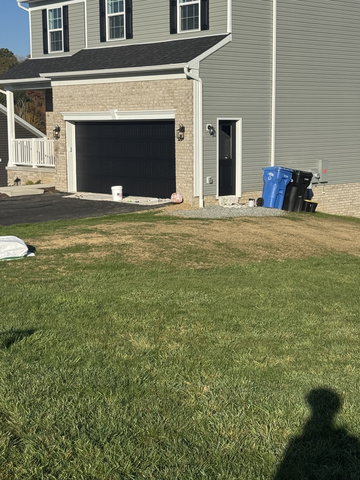 After: garage door and side entry door refinished in black